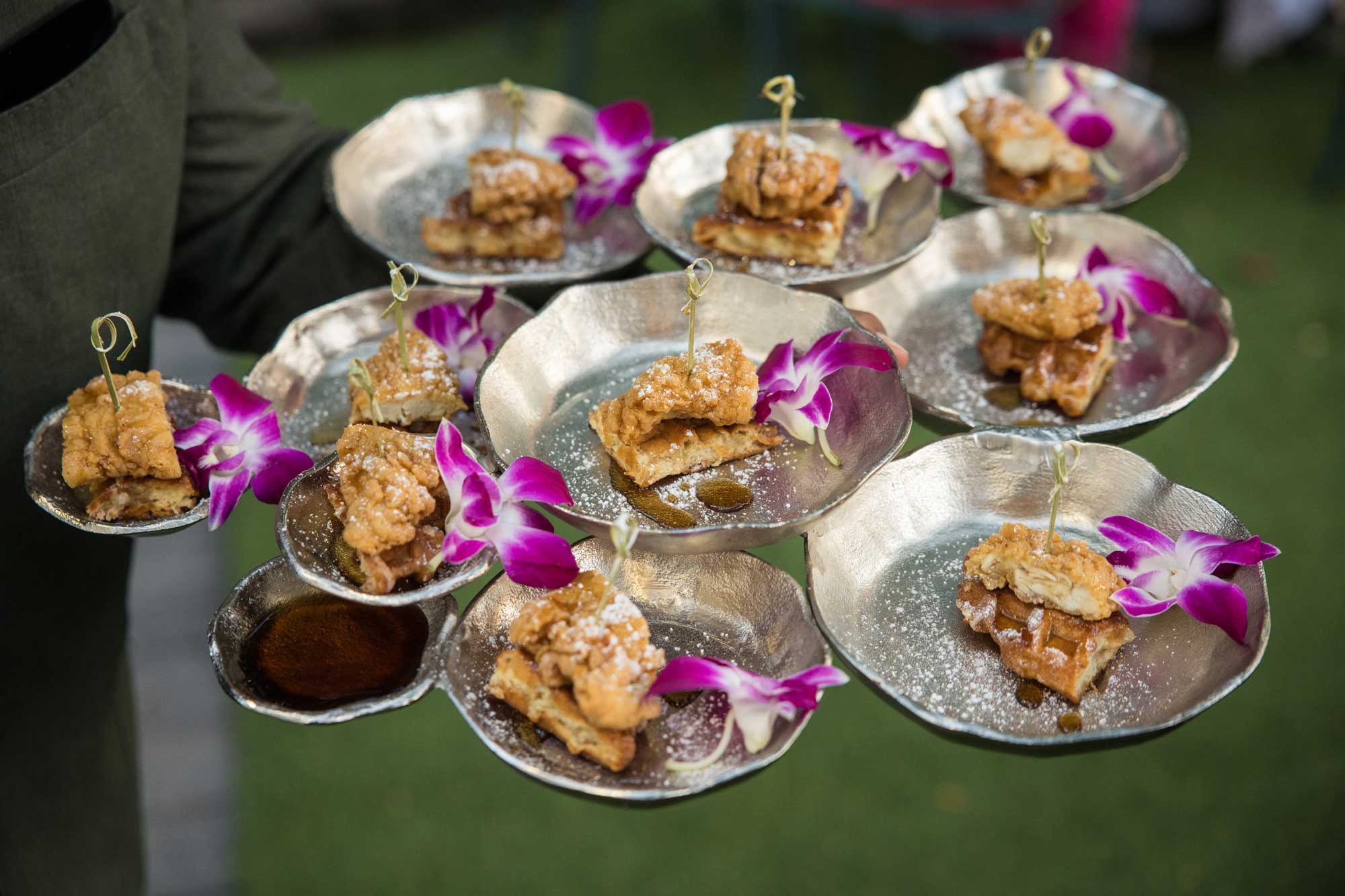 A person holding plates of food.