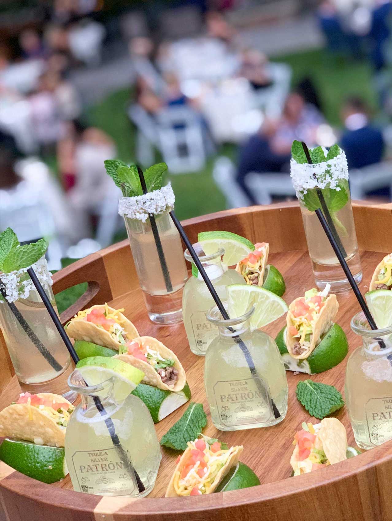 Patron-Margaritas-Tacos-v A tray of drinks and tacos.