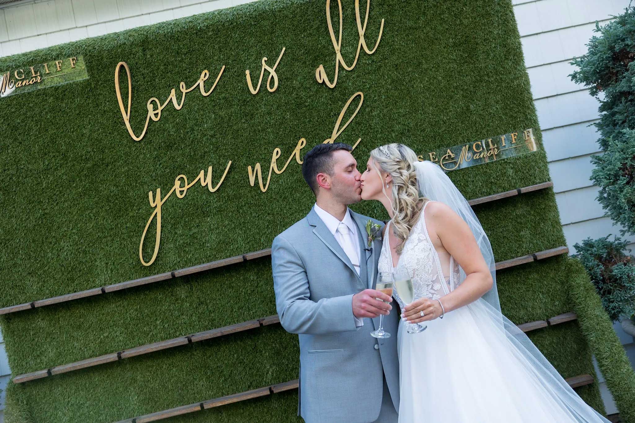 google-review-louis-amanda-sea-cliff-manor A man and woman kissing in front of a sign.